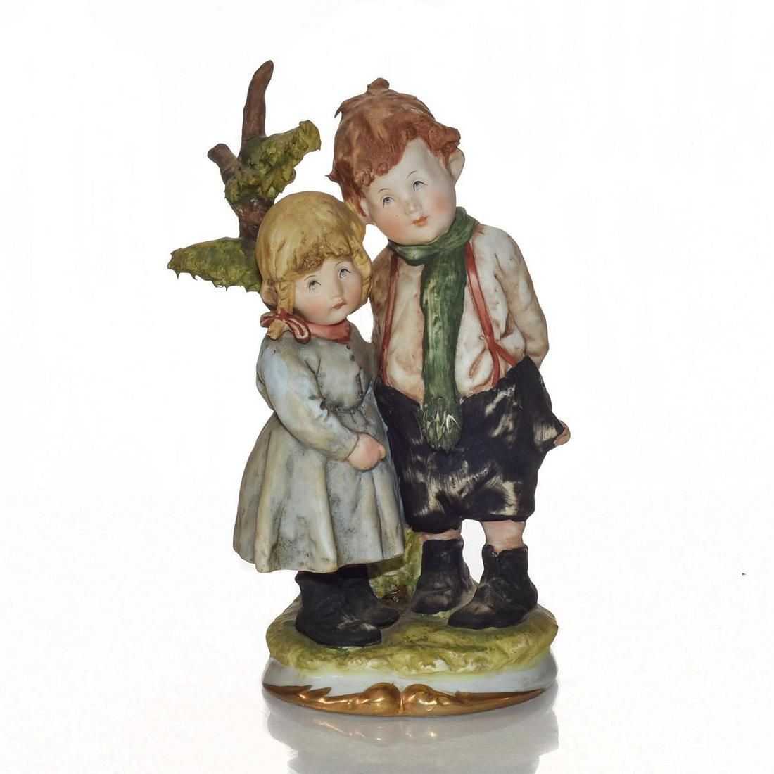 CAPODIMONTE ITALIAN CERAMIC FIGURE, BOY AND GIRL 7298: Porcelain; matte; gilded base. Young children standing by tree. Issued: 20th c. Dimensions: 7"H Manufacturer: Capodimonte Country of Origin: Italy