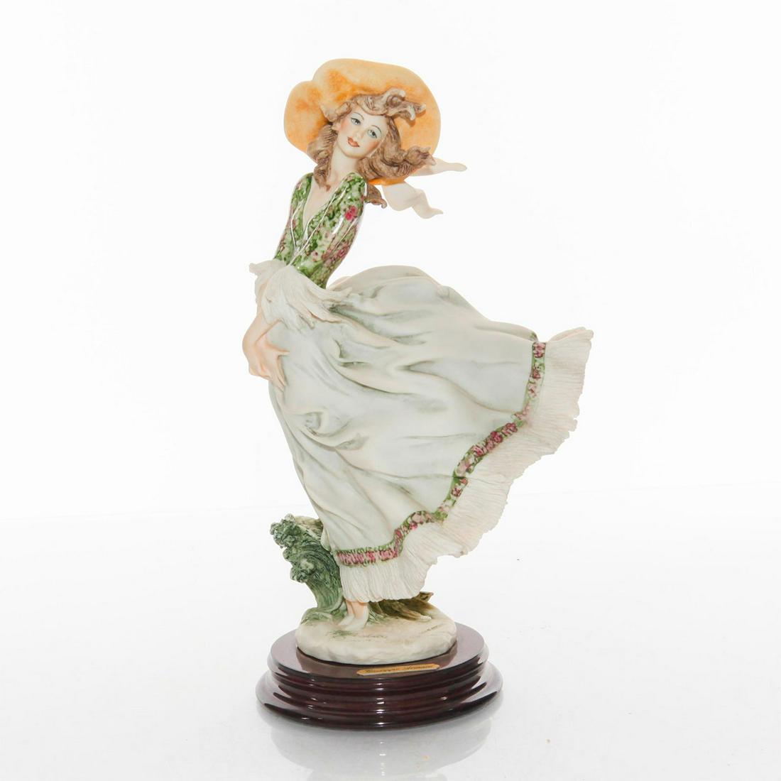 FLORENCE GIUSEPPE ARMANI FIGURINE, SCARLETT 698C: Figure of year 1995. Porcelain; matte finish. Florence backstamp. Depicts lady in billowing skirt. Florence backstamp. Issued: 1995 Dimensions: 10.5"H Manufacturer: Florence Country of Origin: Italy
