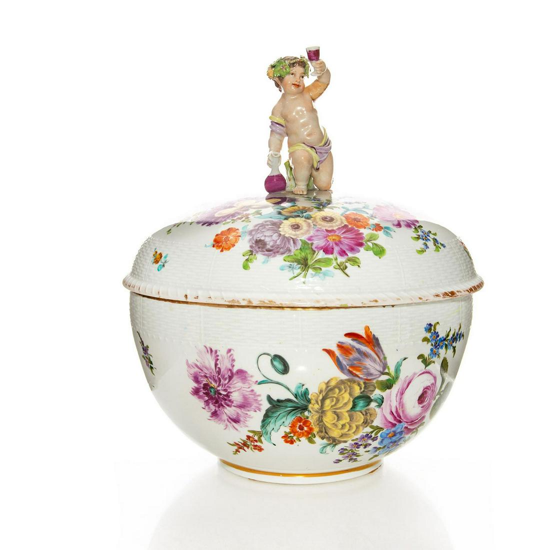 19TH C. BERLIN PORCELAIN KPM LIDDED CENTERPIECE TUREEN: Floral design w. gilt rim, cherubic Bacchus finial. Berlin Porcelain KPM scepter stamp to bottom. Minor chip to wine glass, chips to wreath, damage to glaze on arm. Wear to gilt detail. Issued: c. 188