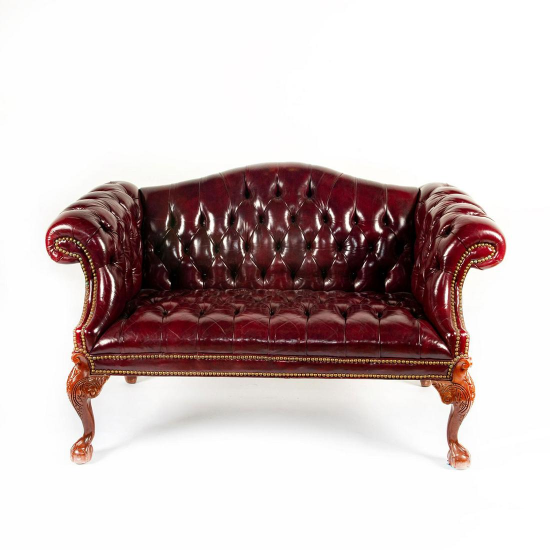 ENGLISH STYLED TUFT RED LEATHER STUDY ROOM COUCH: Chip-n-dale foot styled legs with brass buttons. Issued: 20th c. Dimensions: 58"W x 36H
