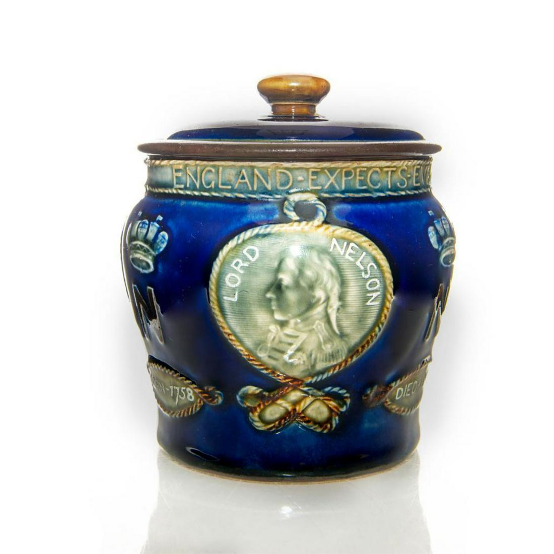 ROYAL DOULTON LORD NELSON LIDDED JAR: Cobalt blue glaze with Lord Nelson naval design. Stamped Royal Doulton to bottom. Issued: Early 20th c. Dimensions: 5"H Manufacturer: Royal Doulton Country of Origin: England