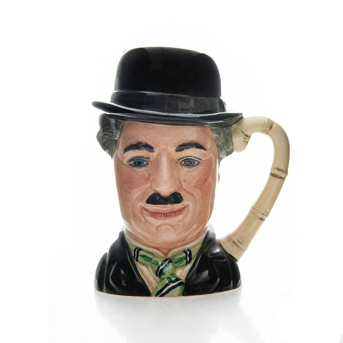 CHARLIE CHAPLIN D6949 - LARGE - ROYAL DOULTON CHARACTER: Black, green, white. Cane handle Ltd. Ed. Doulton backstamp. Artist: William Harper Issued: 20th. c. Dimensions: 7.25"H Edition Number: 927 Edition Size: 5,000 Manufacturer: Royal Doulton Country of O