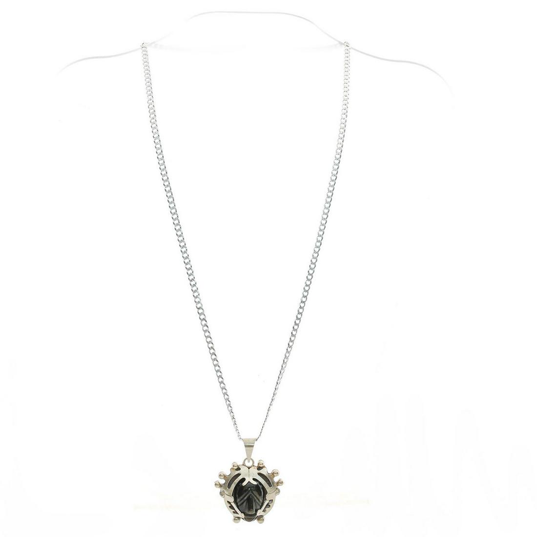 925 SILVER NECKLACE & ALPACA SILVER PENDANT, STONE: Central face shaped black stone. Hallmarked. Approx. wt. 24.5g. Issued: c. 1990 Dimensions: 1.5"L x 1.5"W, pendant Country of Origin: Mexico Provenance: David Farin Collection