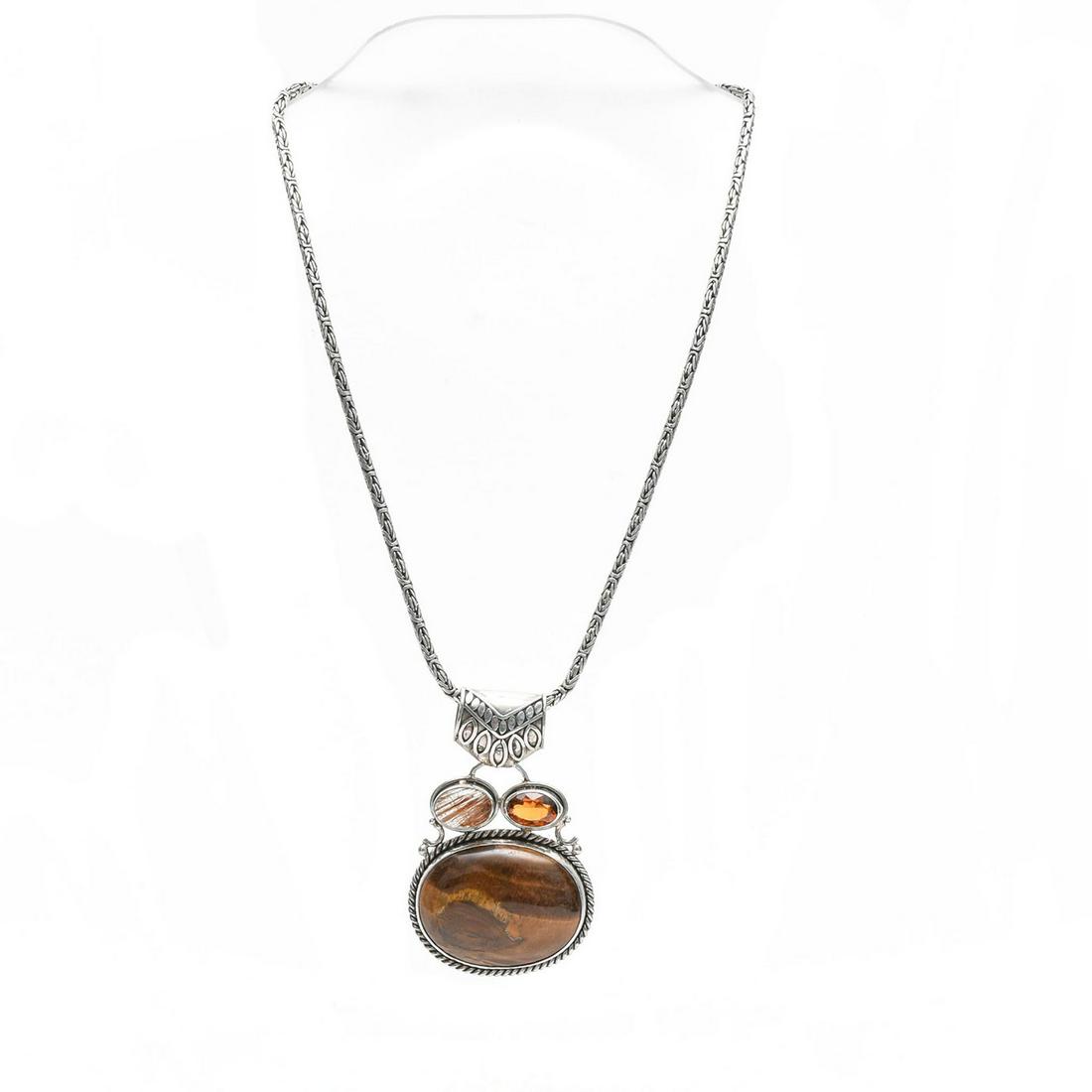 STERLING SILVER NECKLACE W. TIGER'S EYE AGATE: Heavy sterling, w. large tiger's eye cabochon, 2 smaller stones. Total weight is approximately 65g. Issued: 20th c. Dimensions: 20"L Provenance: David Farin Collection