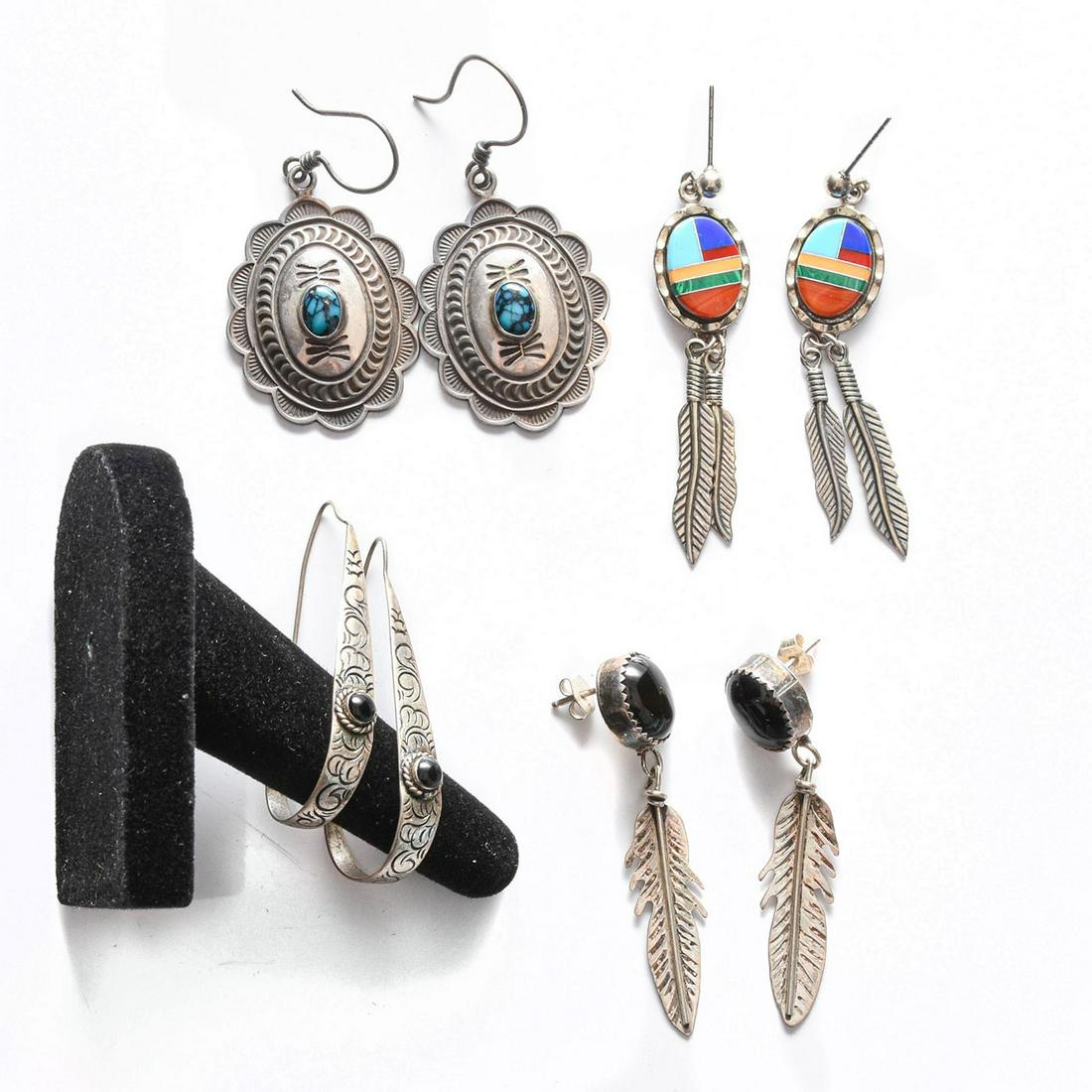 4 PAIRS, NATIVE AMERICAN STERLING SILVER EARRINGS: Feather, geometric silver designs w. inset stones. Total weight is approximately 27.3g. Issued: 20th c. Dimensions: 2"H, largest Country of Origin: United States Provenance: David Farin Collection