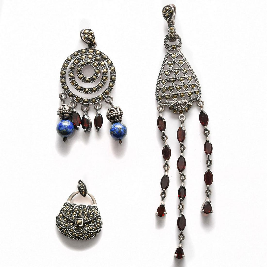 3 ART DECO STERLING SILVER AND MARCASITE PENDANTS: Adorned with garnet, lapis. Each stamped 925. Total weight is approximately 30.9g. Issued: 20th c. Dimensions: 4.5"H, largest Provenance: David Farin Collection