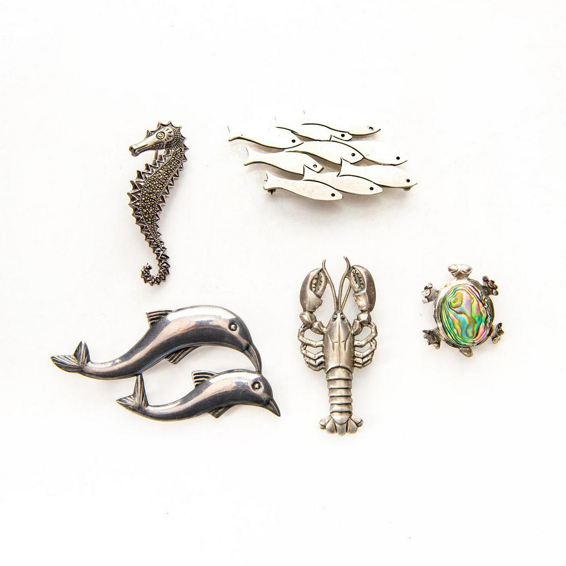 GROUP OF 5 925 SILVER PENDANT PINS, MARINE THEMES: Dolphins, lobster, seahorse, turtle, school of fish. Hallmarked. Issued: c. 1980 Dimensions: 1.75"H x 3"W, largest Provenance: David Farin Collection