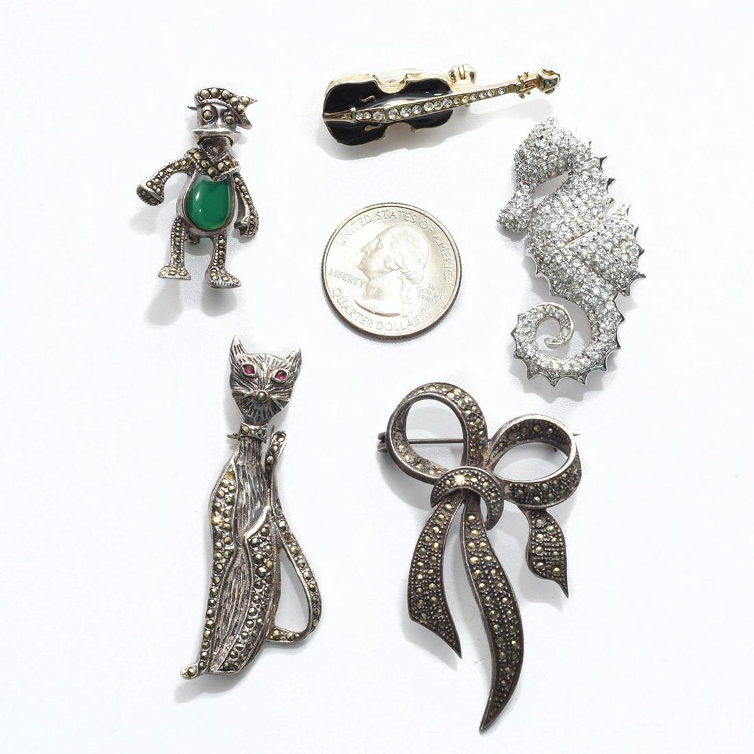 GROUP OF 5 VINTAGE MARCASITE PENDANT BROOCH PINS: Cat, seahorse, violin, Donald Duck and ribbon bow. 3 with stones. Issued: c. 1980 Dimensions: 2.5"L, largest Provenance: David Farin Collection