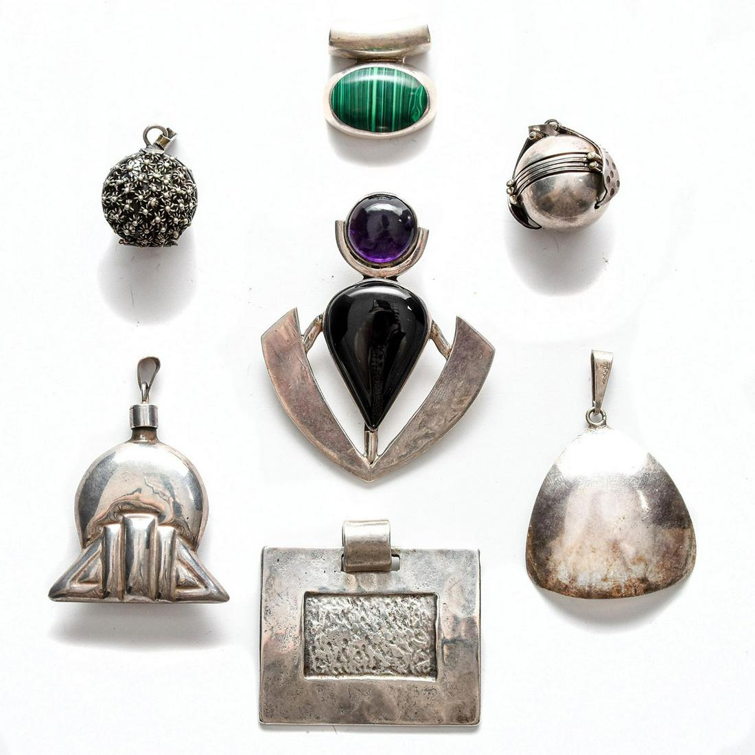 7 STERLING SILVER NECKLACE PENDANTS: Geometric designs, 2 w. inset stones. Total weight is approximately 102g. Issued: 20th c. Dimensions: 2.5"H, tallest Provenance: David Farin Collection