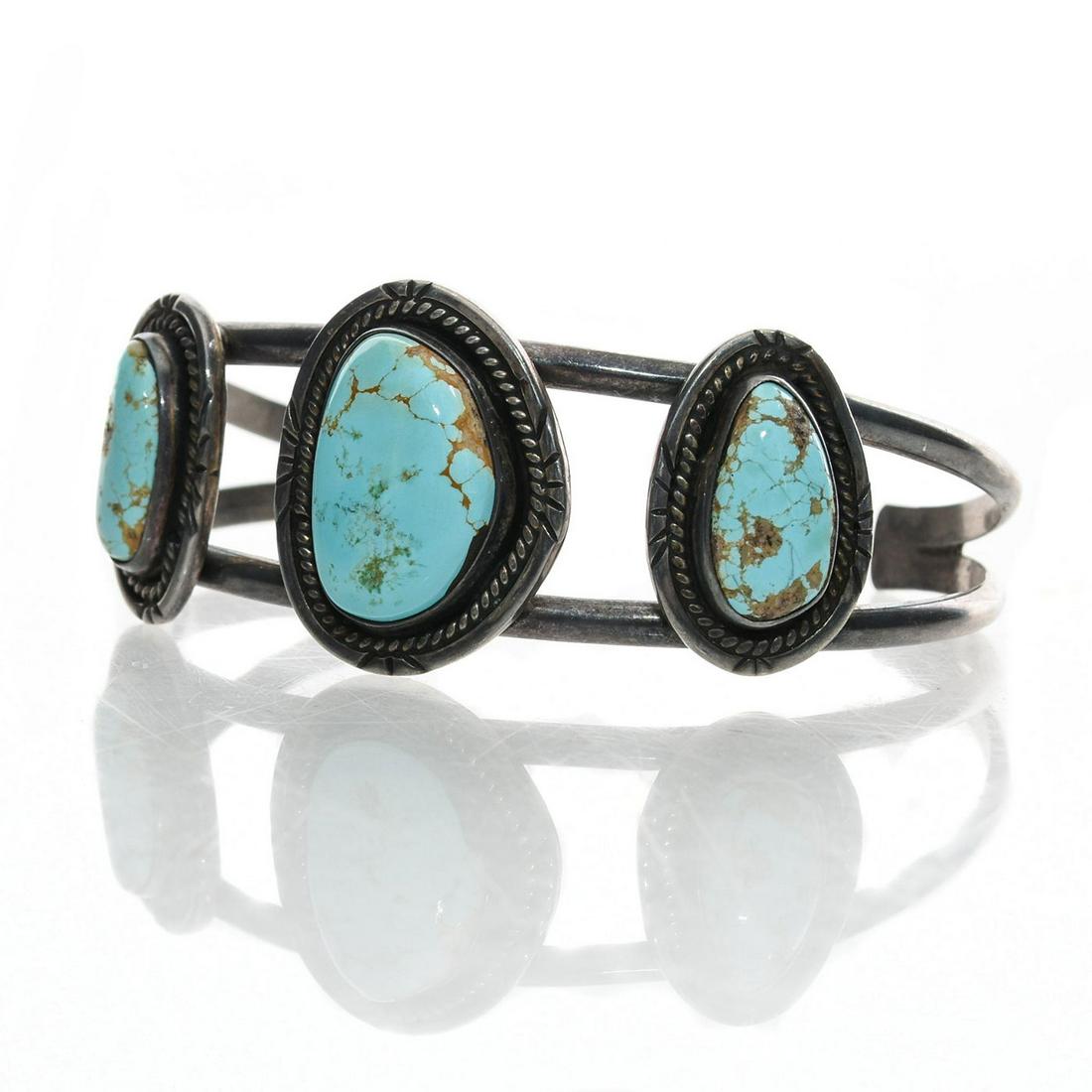 SILVER NAVAJO NATIVE AMERICAN TRIBAL TURQUOISE CUFF: Three stones with russet inclusions. Approx. weight 28 grams. Issued: c. 1990 Dimensions: 2.5"D Country of Origin: United States Provenance: David Farin Collection