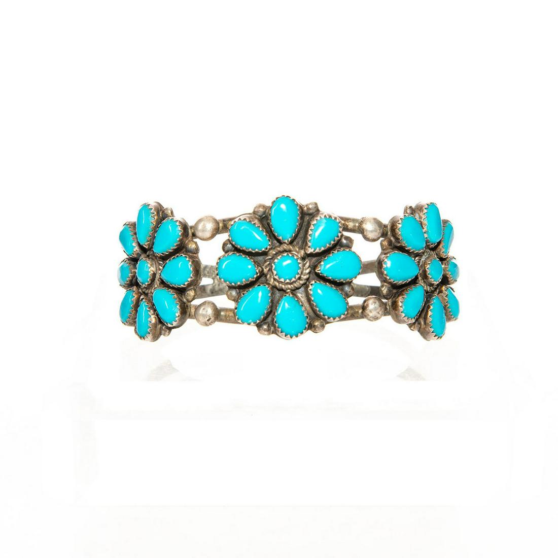 STERLING SILVER NAVAJO TRIBAL TURQUOISE CUFF BRACELET: Hallmarked with artist stamp TL. 27 stones. Approx. wt. 36g. Artist: TL Issued: c. 1995 Dimensions: 2.5"D Country of Origin: United States Provenance: David Farin Collection