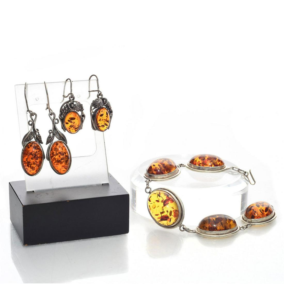 VINTAGE BALTIC AMBER SILVER BRACELET AND EARRINGS: Spherical link bracelet; amber inlay; 2 pairs amber drop earrings. Artistically crafted in in silver frame. Amber is associated with luck, love and strength. 1.75"L, largest earring. Total approx. wei