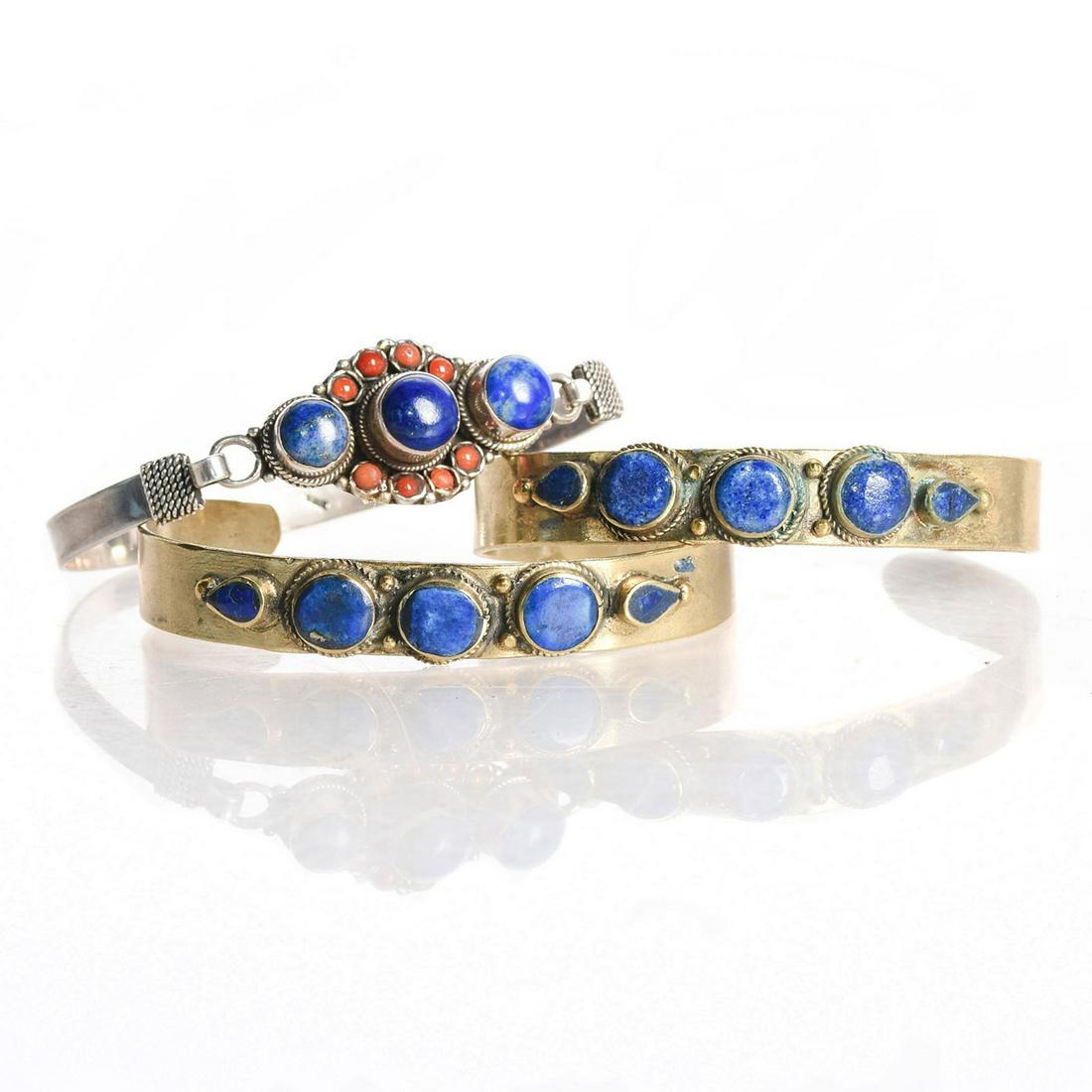3 VINTAGE TRIBAL LAPIS CUFF BRACELETS: Metal frame; deep blue lapis stones encircled by twisted metal. One piece has latch at the sides. 6.25"C, size. Issued: 20th c. Dimensions: 3"W, largest Provenance: David Farin Collection