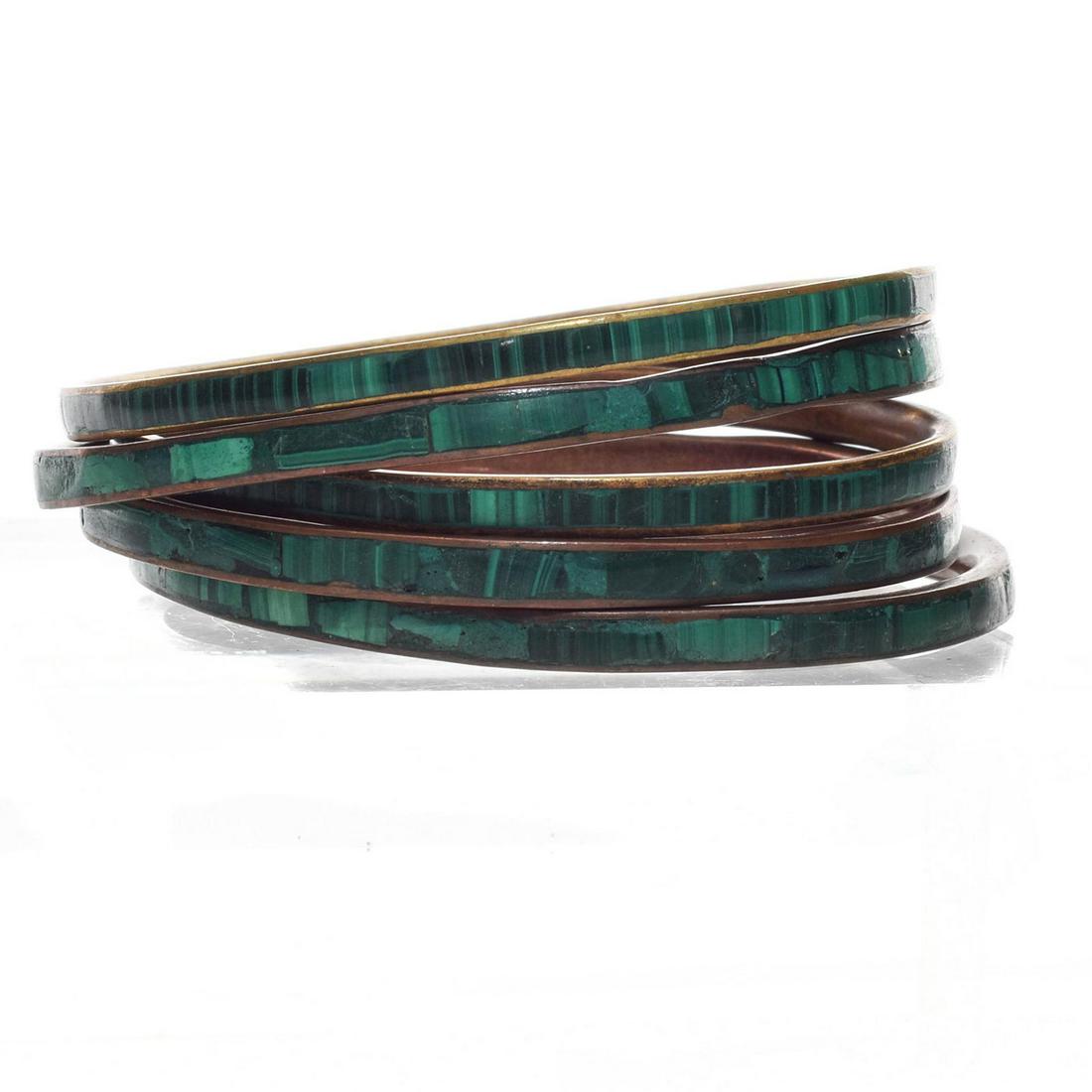 GROUP OF FIVE CRUSHED MALACHITE BANGLE BRACELETS: Copper with a profusion of encircling deep green crushed stone. Issued: c. 1970 Dimensions: 2.5"D Country of Origin: Israel Provenance: David Farin Collection