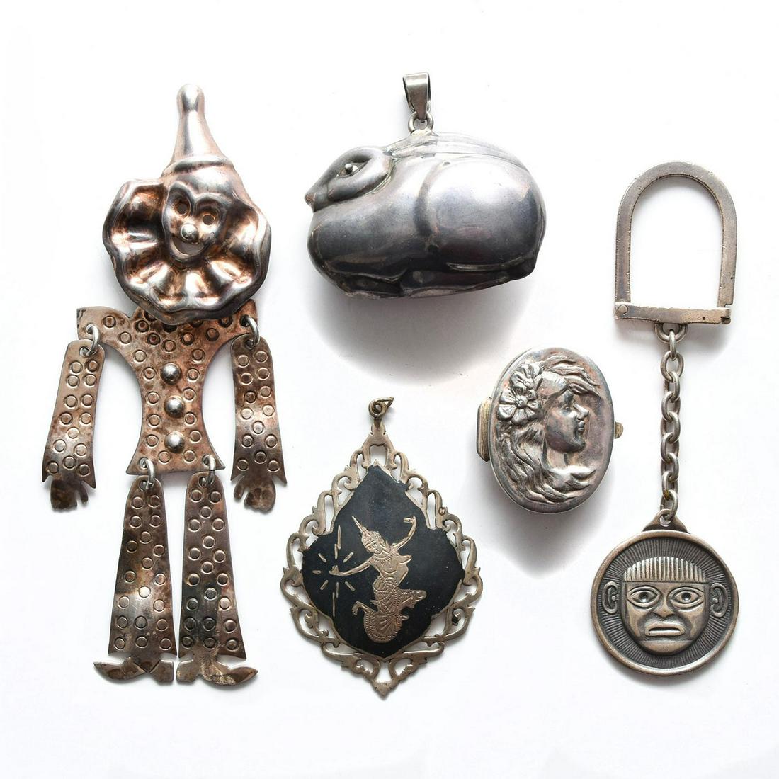 5 PIECES, STERLING SILVER JEWELRY AND ACCESSORIES: 2 pendants, pin, keychain, and pill box. Each marked sterling or 925. Total weight is approximately 80 grams. Issued: 20th c. Dimensions: 5"H, clown pin Provenance: David Farin Collection
