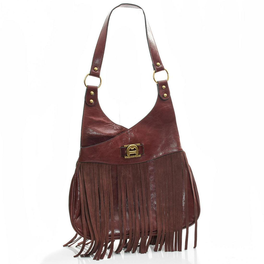 ETIENNE AIGNER 'REDUX 70'S' FRINGED SHOULDER BAG: Burgundy leather and suede fringed vintage purse. Etienne Aigner shoulder bag from the 70's 'Redux collection. Burgundy glazed genuine leather with suede leather fringe. Brass hardware. Five interior 