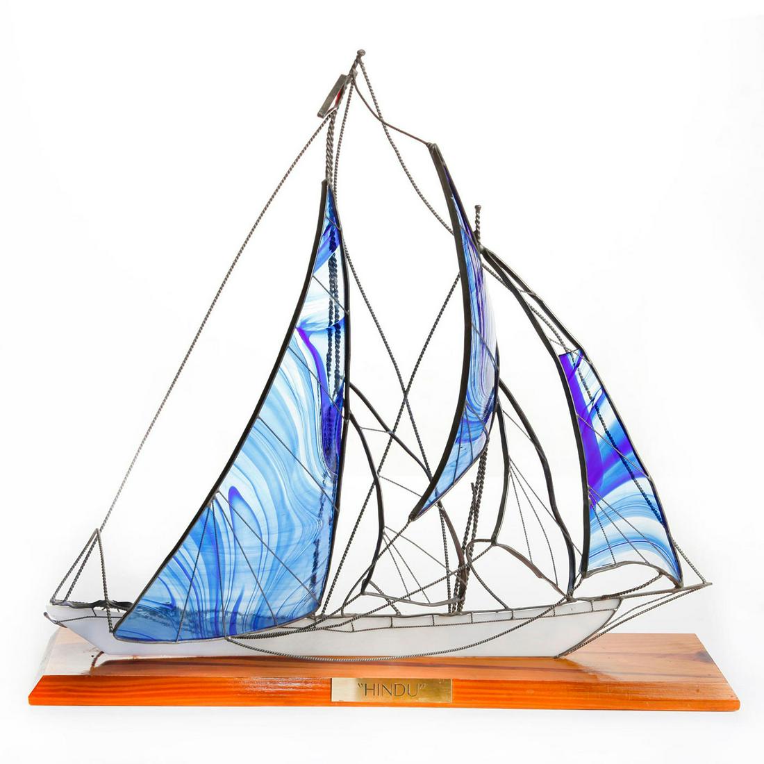 VINTAGE GLASS AND METAL SAILING SHIP SCOONER HINDU: Mid century statue sculpture of Art Deco era Newport race boat. Produced with decorative glass sails and artistically styled metal rigging framing. Presented on a decorative wooden base, with nameplat