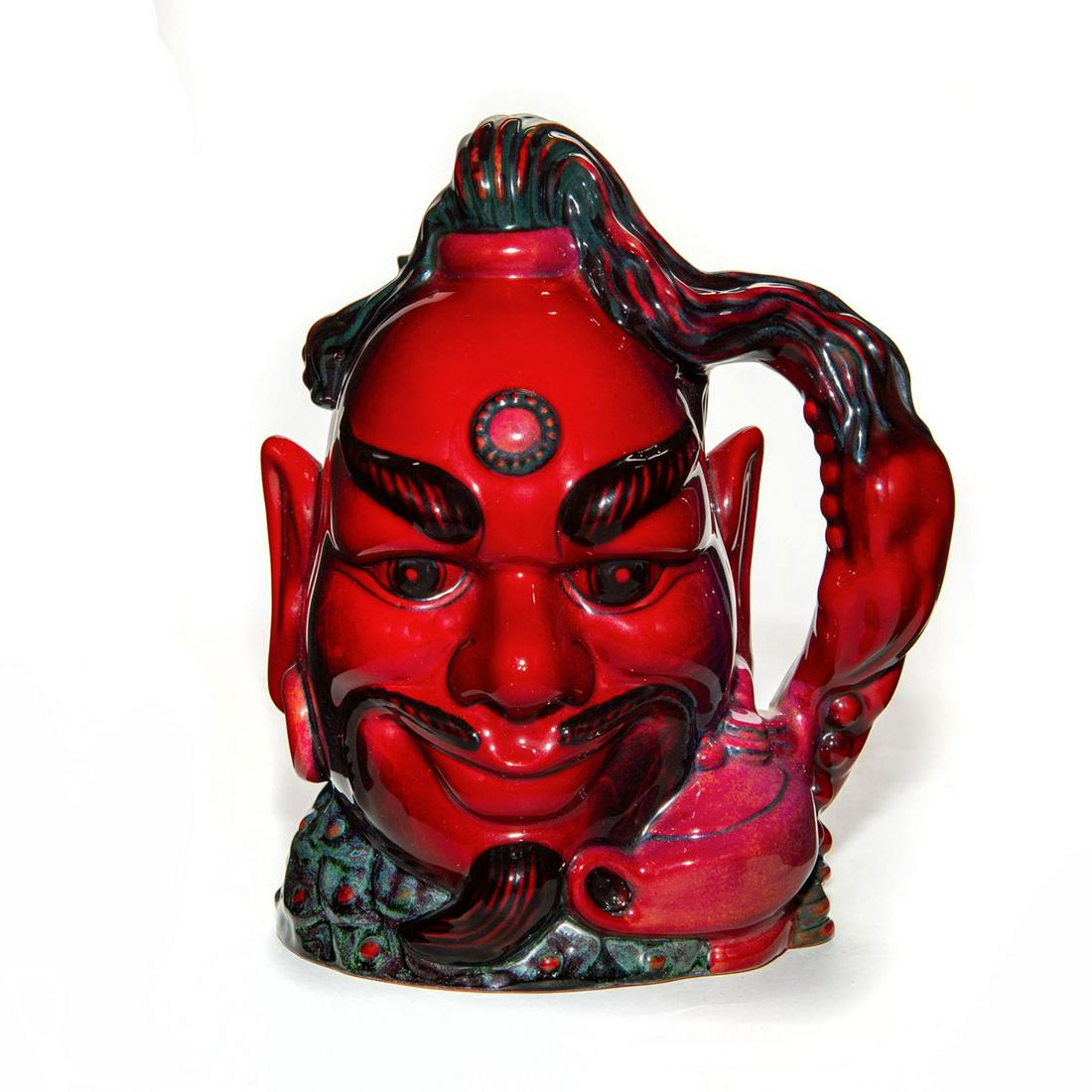 ROYAL DOULTON LG FLAMBE CHARACTER JUG ALADDINS GENIE: D6971. Issued in 1994 in limited edition of 1500. Lamp, ghost form and tassel handle. First jug to be decorated in flambe. Royal Doulton backstamp. Artist: David Briggs Issued: 1994 Dimensions: 7.5"H 