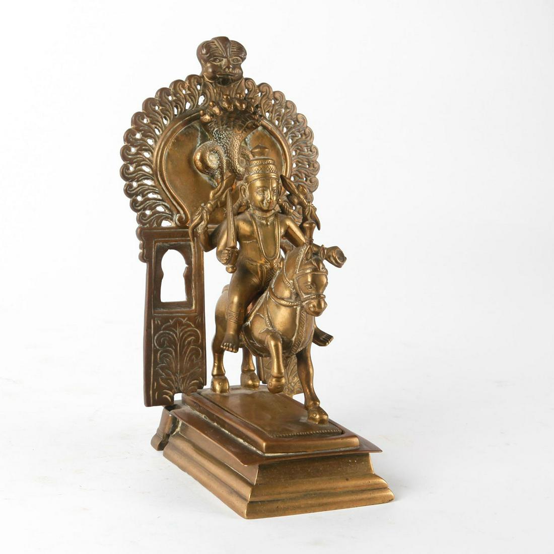 INDIAN BRASS SCULPTURE, SHIVA ON HORSE: Principal Hindu deity on horse with sword leaving Uma Maheshwari temple. A striking brass temple altar figural group modeled as the Hindu divinity Shiva mounted on a horse. The Shiva figure is separat