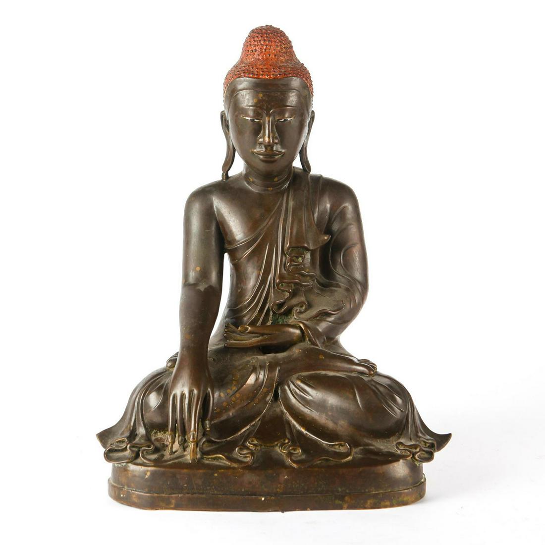 LARGE 19TH C. BURMESE MANDALAY BRONZE BUDDHA: Buddha sitting in lotus position. A superlative bronze figure of Gautama Buddha, depicted in lotus position, his head topped by the Ushnisha, or crown of hair, represented in tight curls and one of t