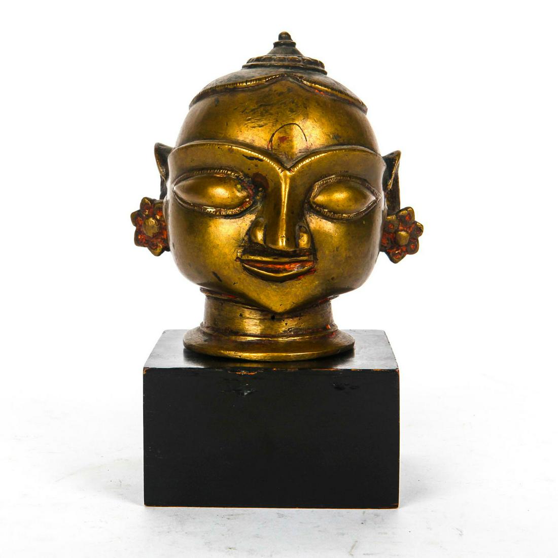 ANTIQUE BRASS TEMPLE ALTAR ORNAMENT, HEAD OF PARVATI: India. Hand cast representation of Hindu goddess of love and marriage. A 19th century Indian temple altar decoration modeled as Parvati Gauri, the Hindu goddess of fertility, love, beauty, marriage, c