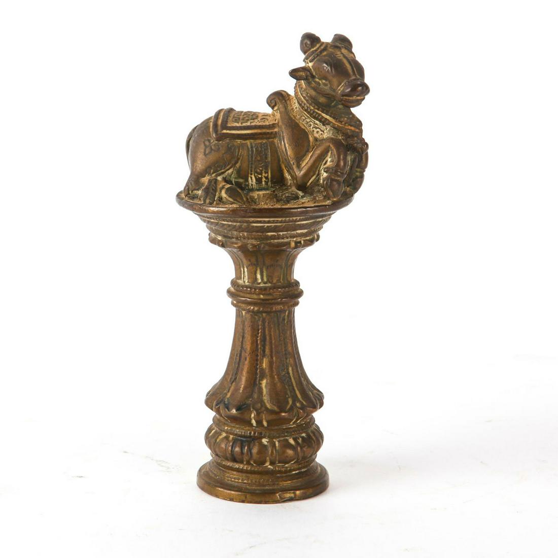 ANTIQUE INDIAN NANDI BULL BRASS ALTAR FIGURINE: Bull laying on pedestal. Represents Nandi in Hindu rituals. An evocative c. 18th-19th century brass metal temple figurine of Nandi, the mount of Shiva. Very fine casting. Total approx. weight 730g. Is