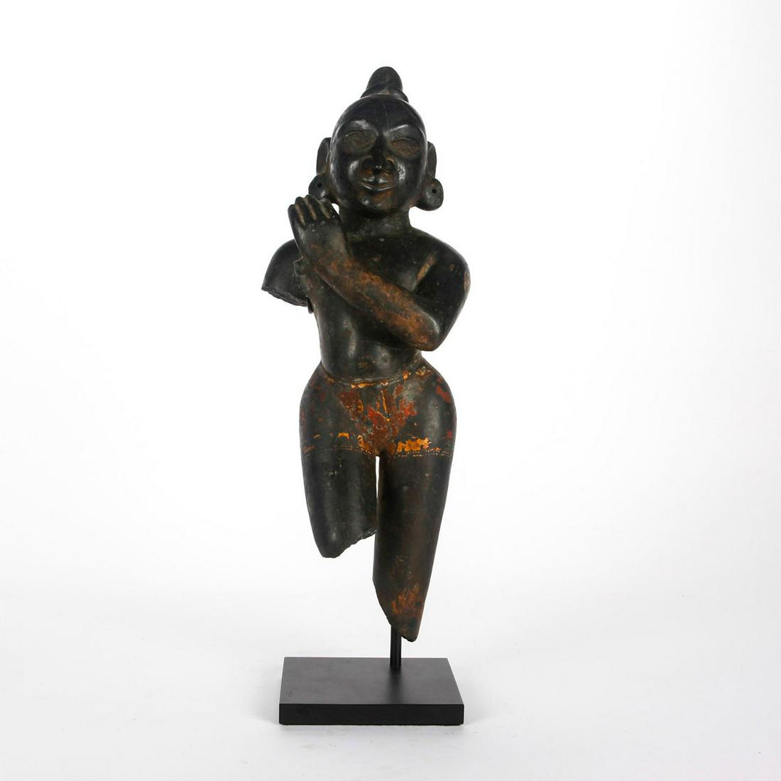 13TH CENTURY BASALT STATUE, DANCING KRISHNA, EASTERN: The youthful avatar of Vishnu capering and playing flute. Primitivistic large schist figure of Krishna, a major deity in Hinduism, worshipped as an avatar of Vishnu and also as supreme in his own rig