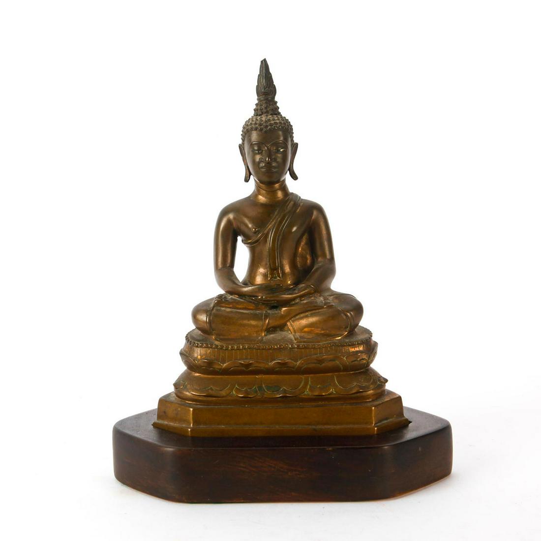 THAI BRONZE BUDDHA SEATED IN DOUBLE LOTUS POSE: An exquisite c. 18th-19th century heavy bronze statue the Amithabha Buddha. Gautama Buddha is modeled with a flaming finial and his hair in the knotted Ushnisha style. With antique remnants of gildin