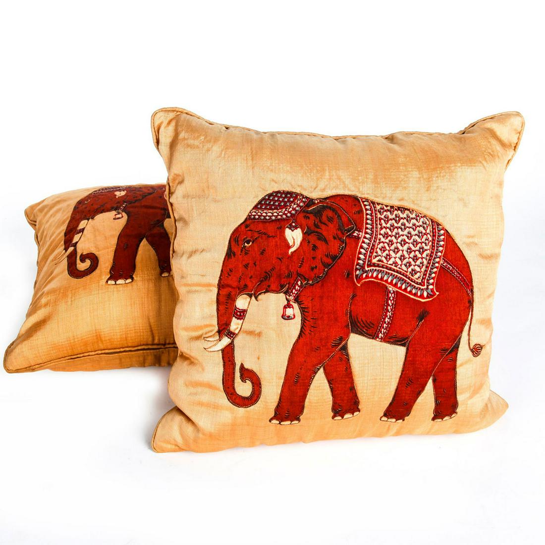 PAIR OF ASIAN SILK ELEPHANT CUSHIONS: Pair of silk cushions with detailed Asian elephants. The elephants are a vibrant burnt sienna. Cushions are from Jim Thompson House in Bangkok, Thailand. There is slight bleeding from the black outlin