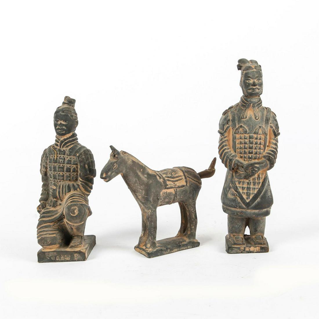THREE JAPANESE EBONY CLAY FIGURES, TWO MEN, ONE HORSE: Three ebony clay figures of two men and one horse. Both male figures have inscriptions on base. One in karuta armor kneeling 6"H, the other in traditional Japanese dress standing 7"H. The horse is 4"H