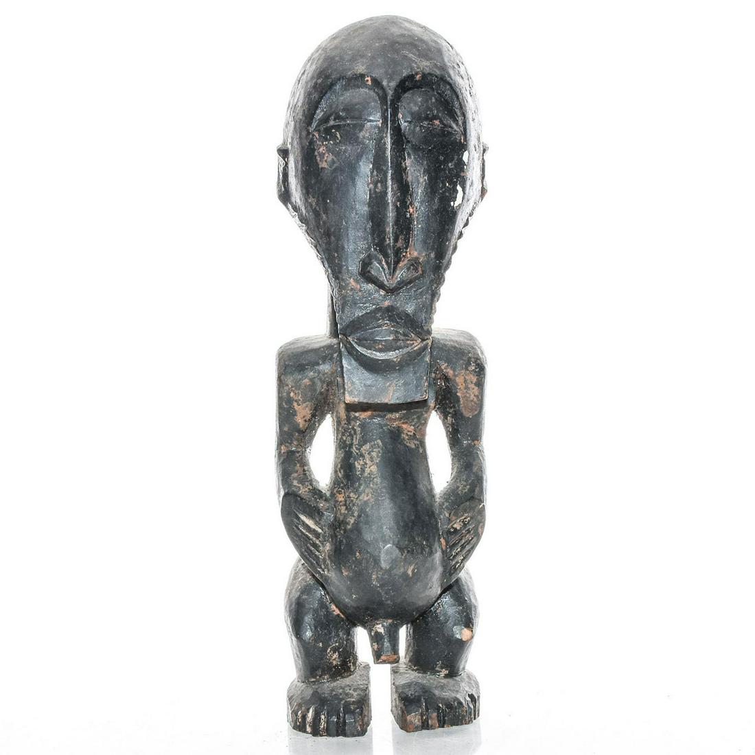 VINTAGE WOODEN PRIMITIVE AFRICAN TRIBAL FOLK ART STATUE: Hand carved, erotica, in the motif of a half kneeling nude man. Issued: c. 1980 Dimensions: 12"H x 3.75"W Country of Origin: Zimbabwe Provenance: David Farin Collection