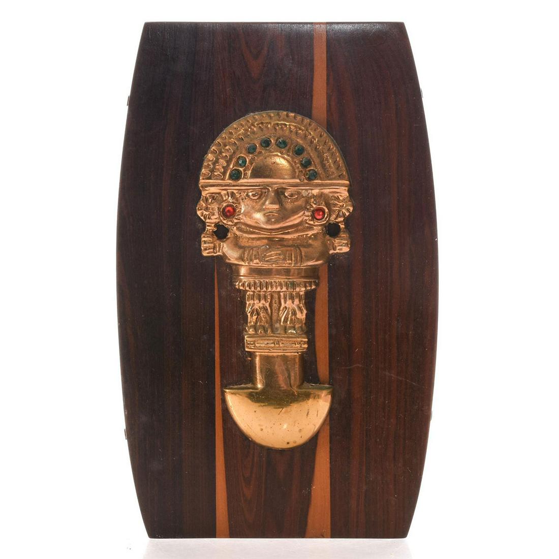 WOOD WALL PLAQUE WITH BRONZE INCAN TUMI: Tumi knife style display representing Incan sun god. Issued: 20th c. Dimensions: 6.25"L x 10"H x 1"D Country of Origin: Peru Provenance: David Farin Collection