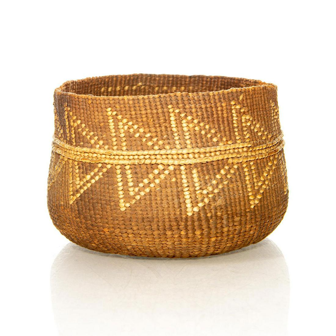 NATIVE AMERICAN TRIBAL WOVEN BASKET BOWL: Traditional design. Encircling patterns of stylized fish symbols. A Native American woven basket bowl hand decorated with encircling stylized Native fish symbols. Issued: c. 1950 Dimensions: 3"H x 5"W