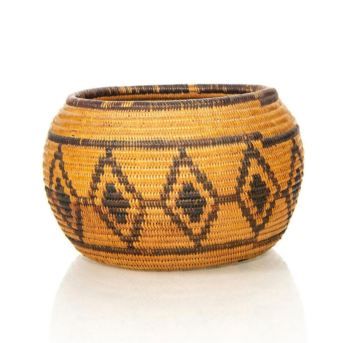 NATIVE AMERICAN TRIBAL WOVEN BASKET BOWL, EYES OF GOD: Traditional design. Encircling motifs of symbolic diamonds. A Native American woven basket bowl with encircling geometric diamond designs, referred to as an Eye of God pattern in Native symbolism. Iss