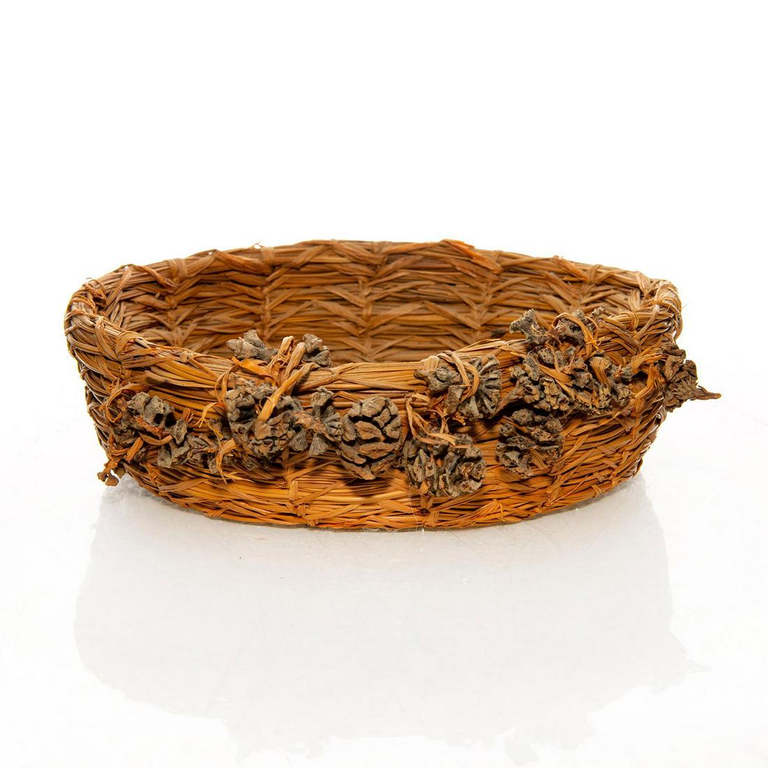 NATIVE AMERICAN TRIBAL WOVEN PINE NEEDLE BASKET, ACORNS: Traditional with finely woven pine needles, unusual acorn accents. A Native American woven basket bowl hand made with tightly woven pine needles and acorn accents. Issued: c. 1950 Dimensions: 2.25"H x