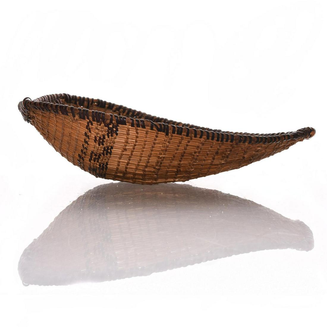 NATIVE AMERICAN TRIBAL WOVEN SCOOP BASKET: Traditional woven tribal design presented in an unusual shell shape. A beautiful and rare Native American woven tribal scoop basket, for winnowing grain or scooping fish. Designed in an unusual shell 