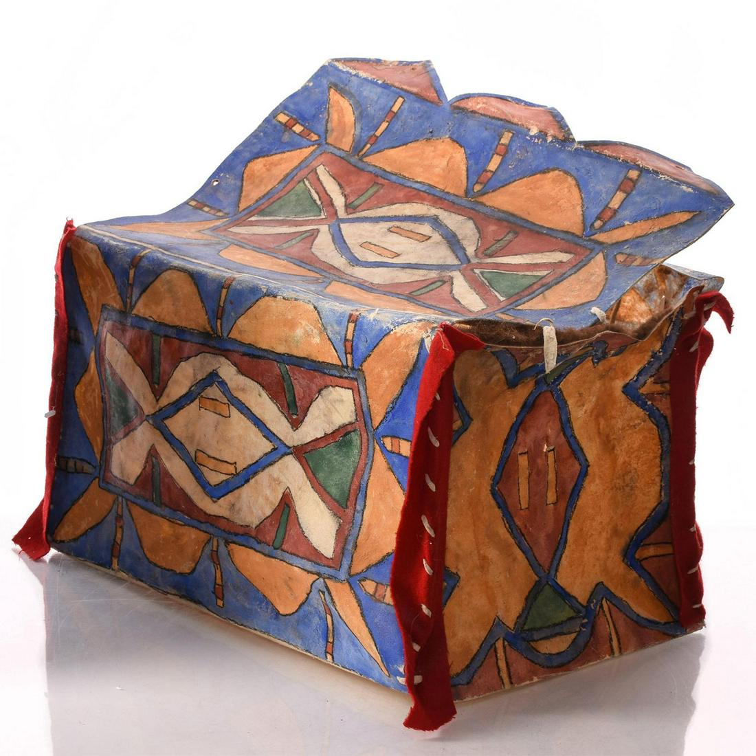 NATIVE AMERICAN LAKOTA SIOUX INDIAN BUFFALO PARFLECHE: Late 19th century. Rawhide in naturalistic colors. Felt accents. A late 19th century Native American Lakotsa Sioux Indian parfleche box made from buffalo hide, hand decorated with naturalistic pigment