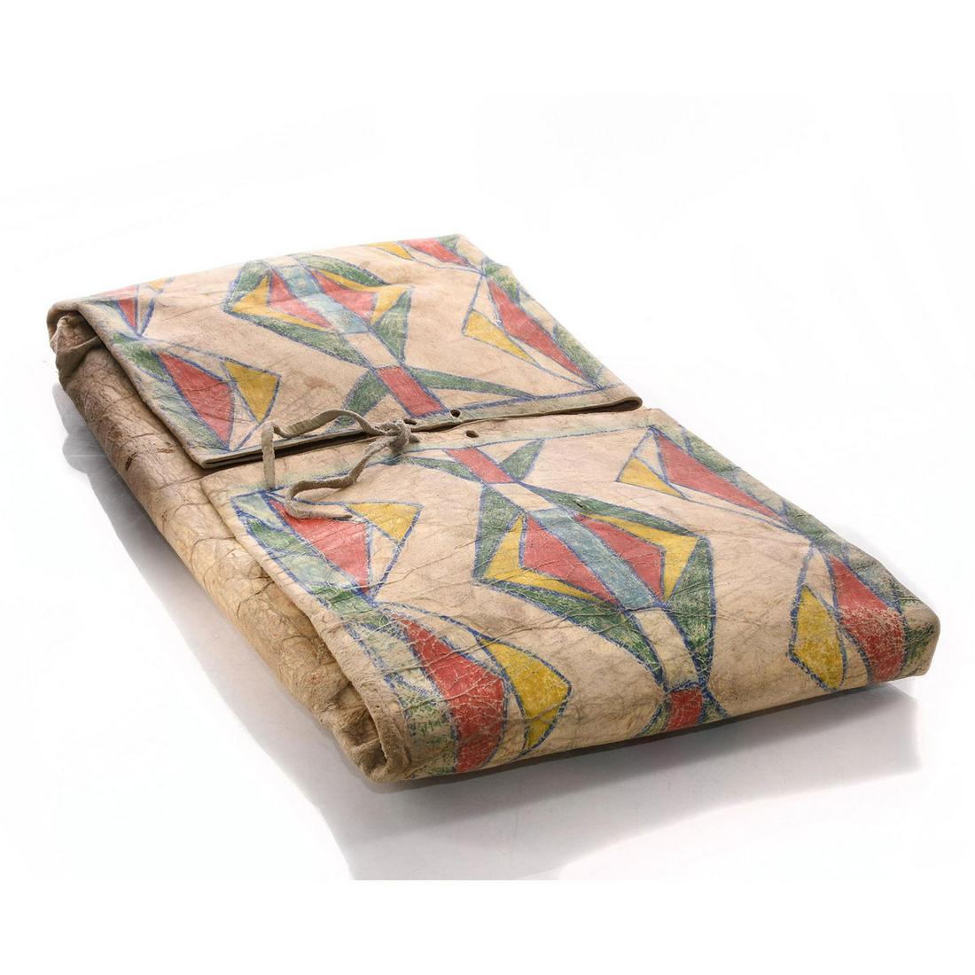 NATIVE AMERICAN BLACKFOOT INDIAN NIITSITAPI PARFLECHE: Early 20th century buffalo hide tribal bag. Naturalistic colors. An early 20th century Native American Blackfoot Niitsitapi parfleche bag made from buffalo hide, hand decorated with naturalistic pigme