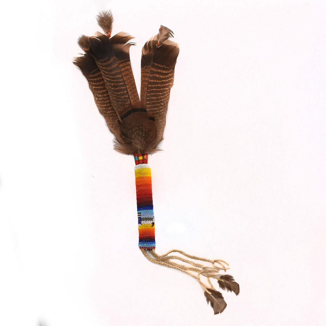 NATIVE AMERICAN TRIBAL POW-WOW DANCE WAND: Ceremonial stick. Exemplary beadwork with turkey feathers and soft hide tassels. Issued: c. 1980 Dimensions: 25"L Country of Origin: United States Provenance: Collection of Mona Brown