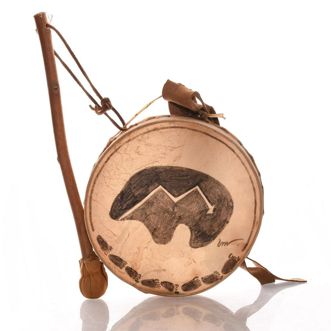 NATIVE AMERICAN SOUTHWEST TRIBAL HAND DRUM AND BEATER: Bear paw motifs on hide drum cover. Leather straps & highlights. This is unusual Native American tribal hand drum is decorated with motifs of bear paws to the edge of the tanned hide drum cover, with