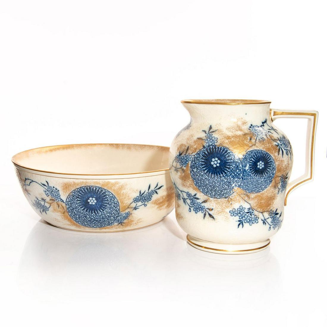 DOULTON BURSLEM BLUE AND WHITE GILDED PITCHER AND BASIN: Raised relief, decorated with Willow and Aster pattern. Bottom base marked US PATENT, DOULTON & SLATERS PATENT. Doulton Burslem backstamp. Issued: 19th c. Dimensions: 9.75"H pitcher, 13.75"D basin Man