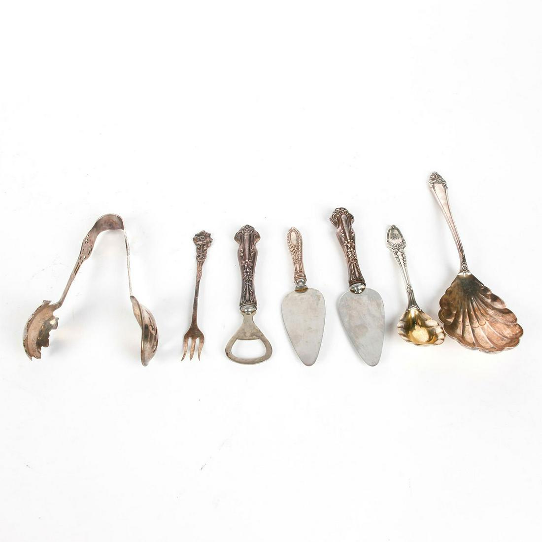 7 PIECES, STERLING SILVER FLATWARE W. ANTI TARNISH BAGS: 6 serving utensils, 1 cocktail fork. Each stamped sterling. Brands include Tiffany & Co, Reed & Barton, and others. Cheese servers and bottle opener have sterling handles with stainless tools. Total s