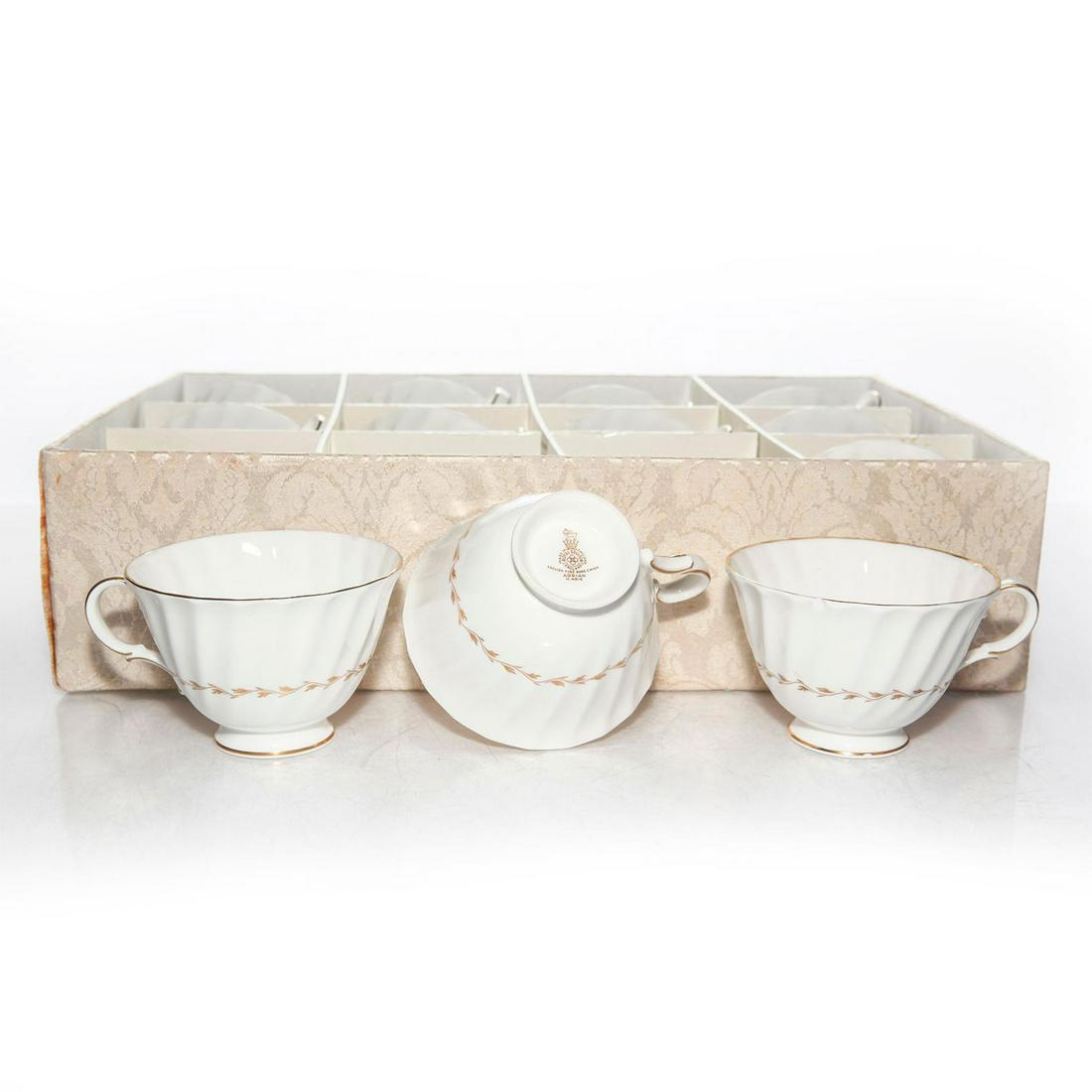 ROYAL DOULTON ADRIAN 12 TEA CUPS H4816, WITH CASE: White fine bone china, profuse gilt decoration. Stamped to base. Issued: c. 1959 Dimensions: 2.5"H x 4.75"W Manufacturer: Royal Doulton Country of Origin: England