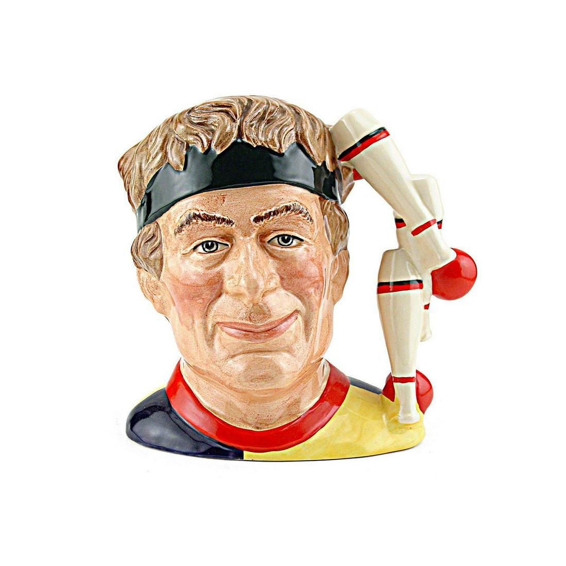 JUGGLER D6835 - LARGE - ROYAL DOULTON CHARACTER JUG: Royal Doulton Character Jug, Juggler D6835 (brown hair, yellow; blue and red tunic; dark green head band). Designed by Stanley J. Taylor, issued 1988 - 1991. Size: 6.5"H (Large) Manufacturer: Royal Do