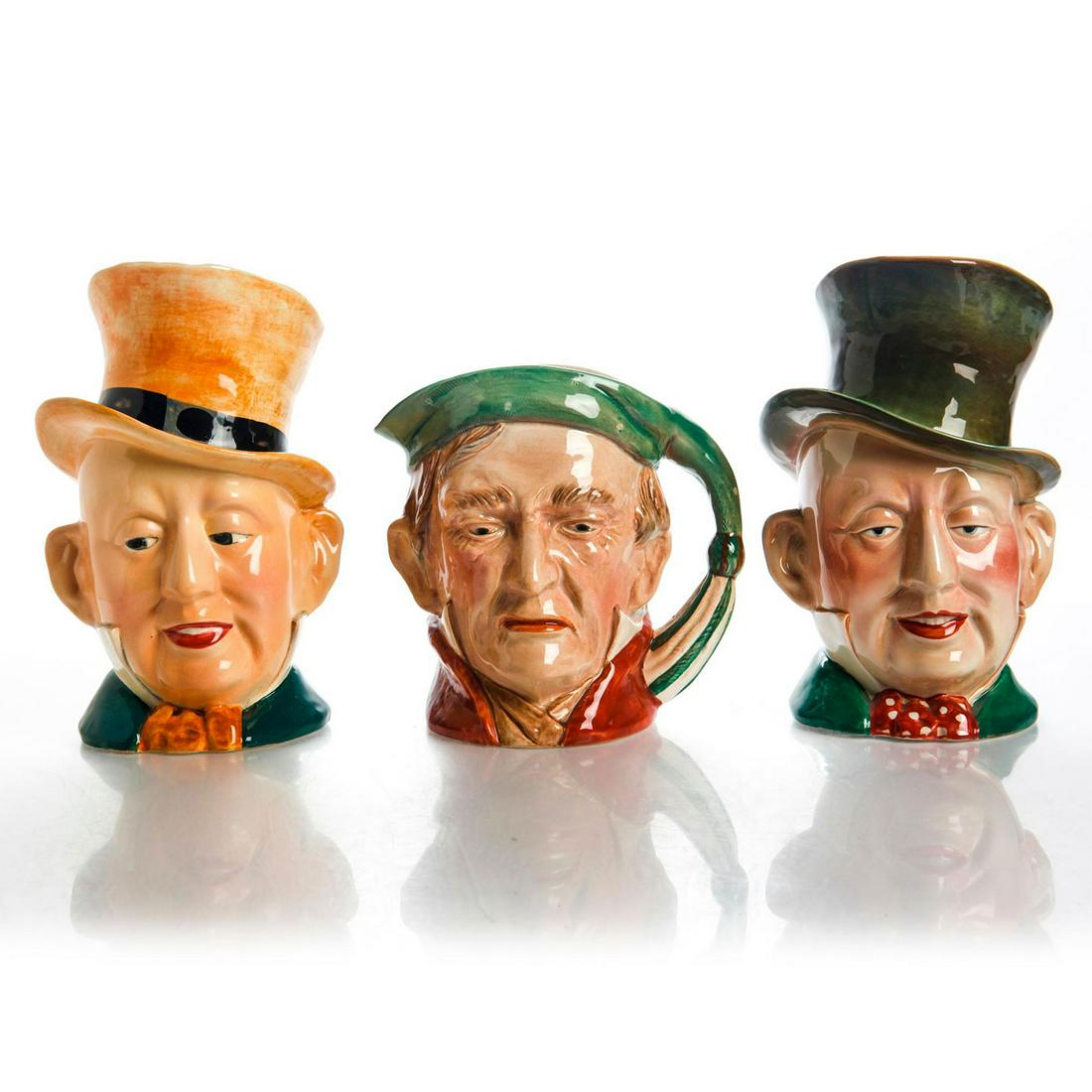 3 LARGE BESWICK WARE CHARLES DICKENS CHARACTER JUGS: 1 Scrooge jug 372; 2 Micawber jugs of different colorways. Light crazing to body. Beswick backstamp. Issued: 20th c. Dimensions: 9"H, tallest Manufacturer: Beswick Country of Origin: England
