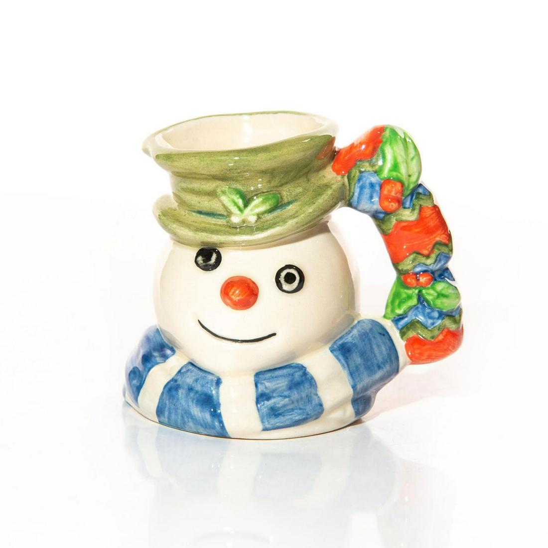 SNOWMAN D7158 - MINI - ROYAL DOULTON CHARACTER JUG: Mini character jug of smiling snowman with green hat and scarf. The handle features mistletoe with vibrant blue, red and green decoration. Issued: 1999 Dimensions: 3"H Manufacturer: Royal Doulton Coun
