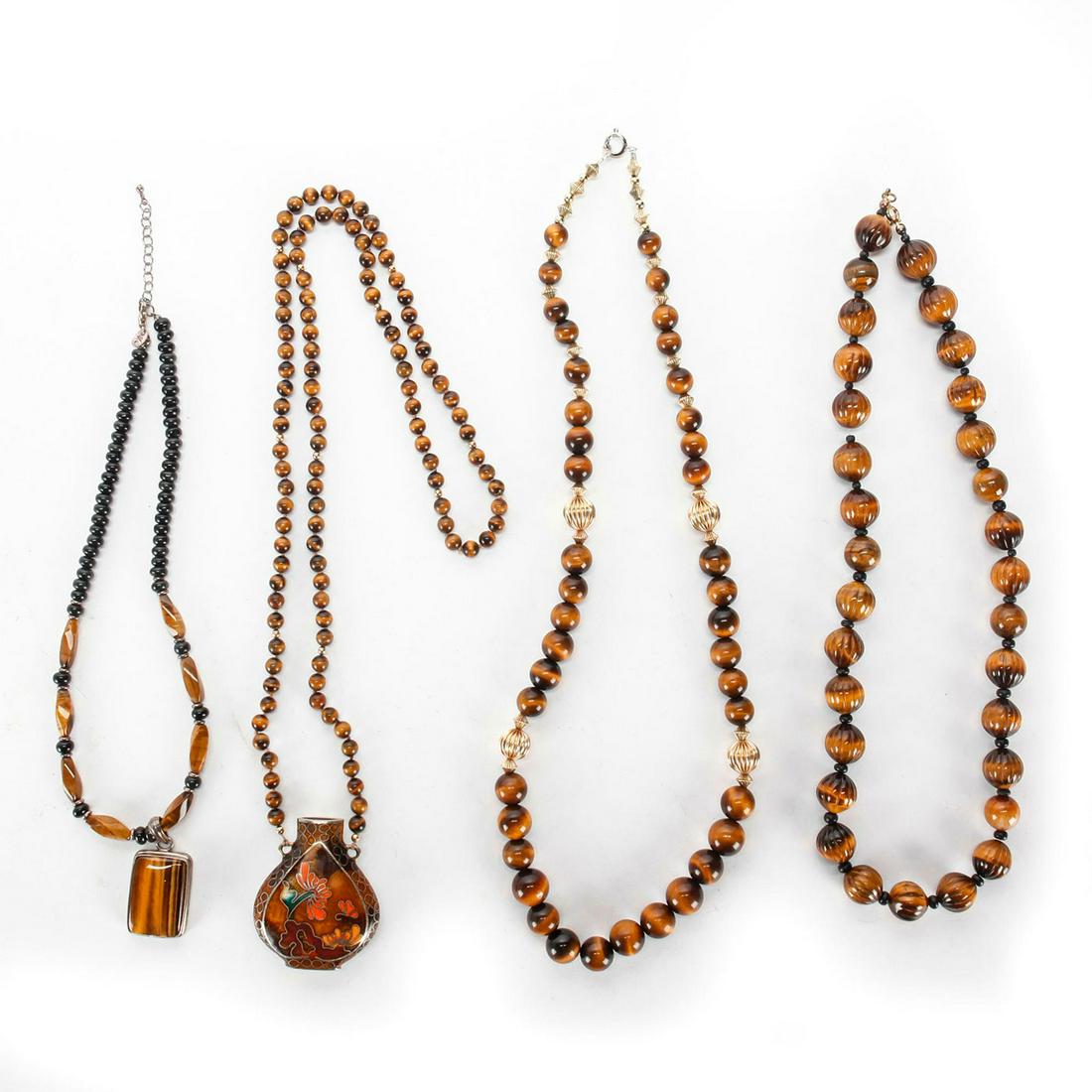 4 VINTAGE TIGER'S EYE BEAD NECKLACES: Beads of tigers eye, pendants of sterling silver, enameled metal. Issued: 20th c. Dimensions: 30"L, longest
