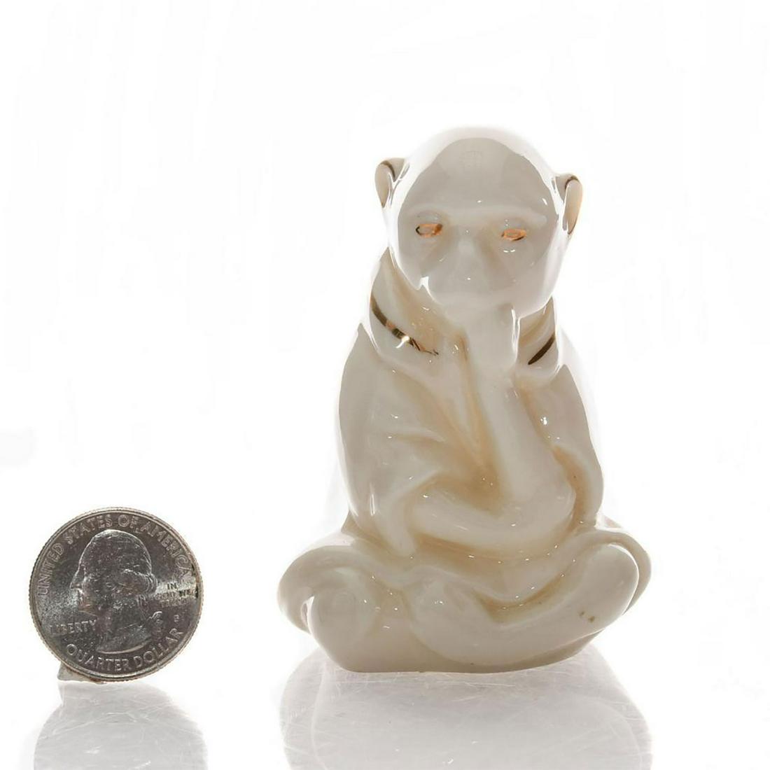 ARCADIAN MINIATURE CRESTED FIGURINE WHITE MONKEY: Accented in gold gilt, handpainted coat of arms to back. Marked CITY OF HEREFORD AD 1645. INVICTA FIDELITATIS PRAEMIUM. Arcadian backstamp. Issued: 20th c. Dimensions: 2.75"H Manufacturer: Arcadian Co