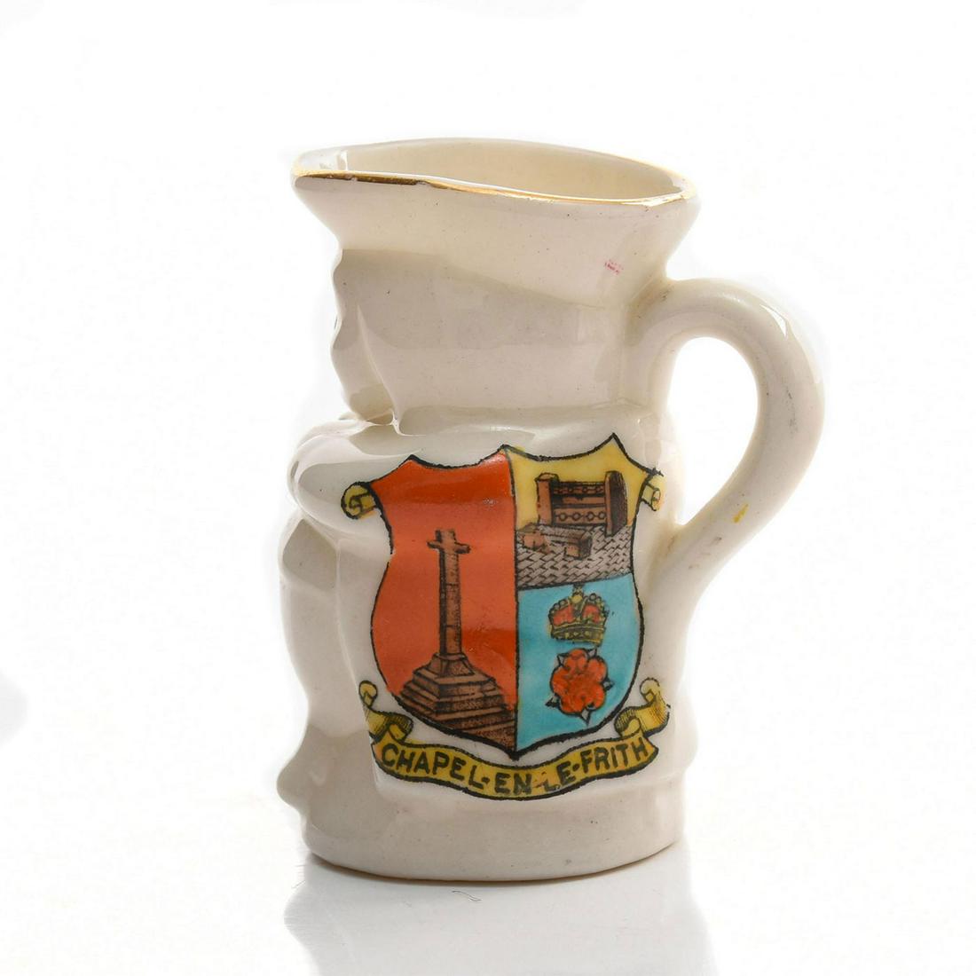 ARCADIAN MINIATURE CRESTED TOBY JUG, CHAPEL EN LE FRITH: Glazed white china with gilt & other decoration. Arcadian stamp. Issued: c. 1950 Dimensions: 2.5"H Manufacturer: Arcadian China Country of Origin: England