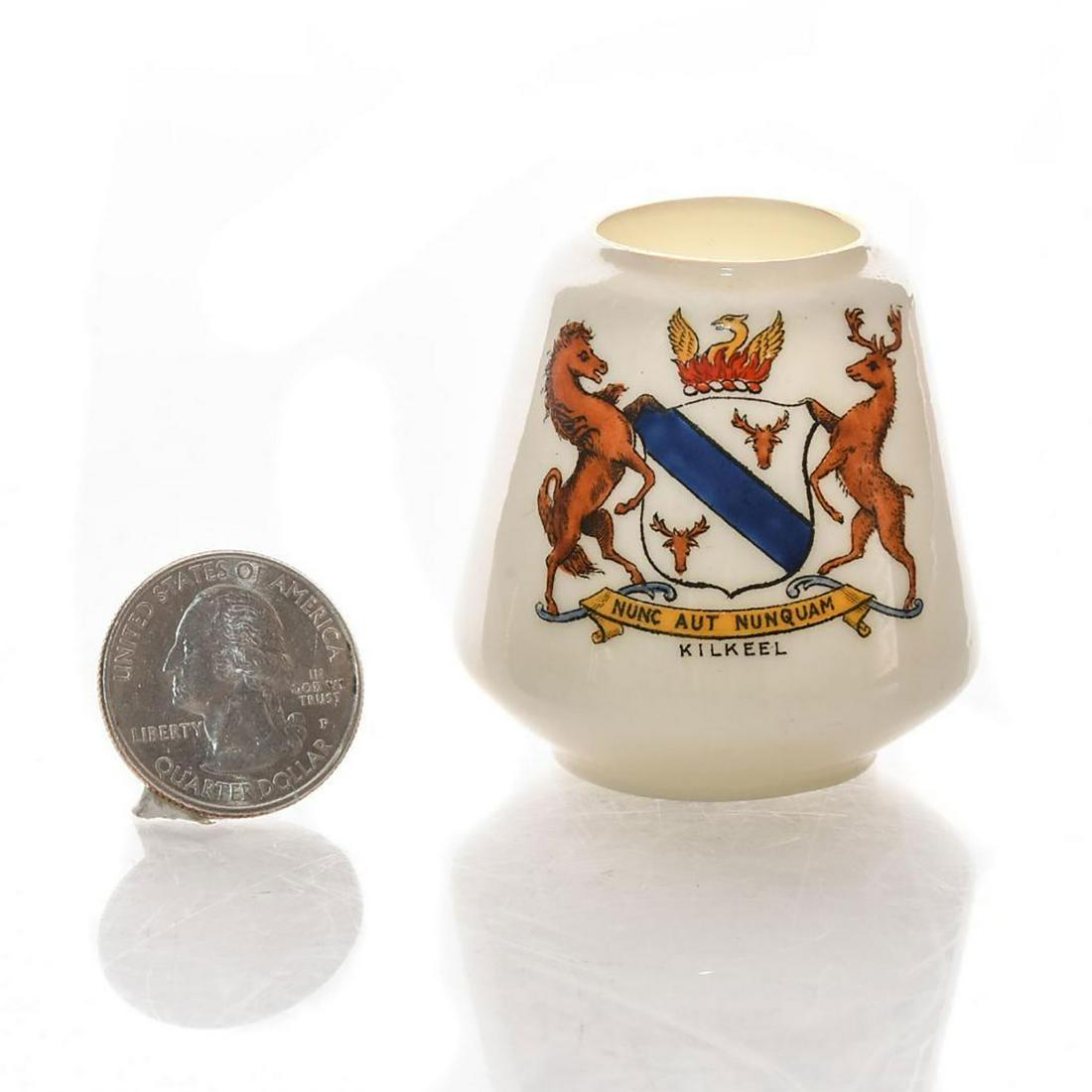 GRAFTON CHINA MINIATURE CRESTED VASE, KILKEEL: Handpainted Kilkeel coat of arms, marked NUNC AUT NUNQUAM. Porcelain manufactured by Egyptian Pottery. Grafton and Egyptian Pottery backstamp. Issued: 20th c. Dimensions: 2"H Manufacturer: Graton Chin